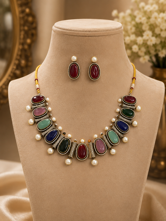 Mahira Heritage necklace set with red, green, and blue stones, pearl accents, stud earrings.