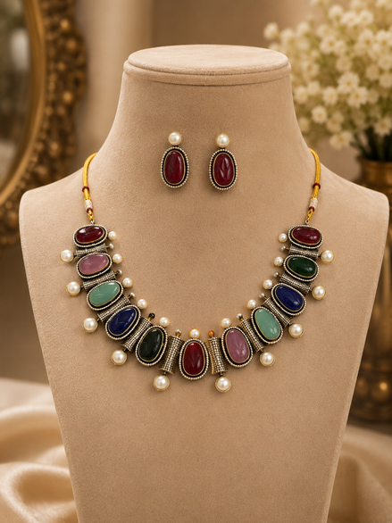 Mahira Heritage necklace set with red, green, and blue stones, pearl accents, stud earrings.