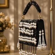 Black pearl shoulder bag with gold clasp, bead stripes, and multiple dangling pearl tassels