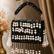 Black pearl shoulder bag with striped bead panels and long dangling pearl tassels