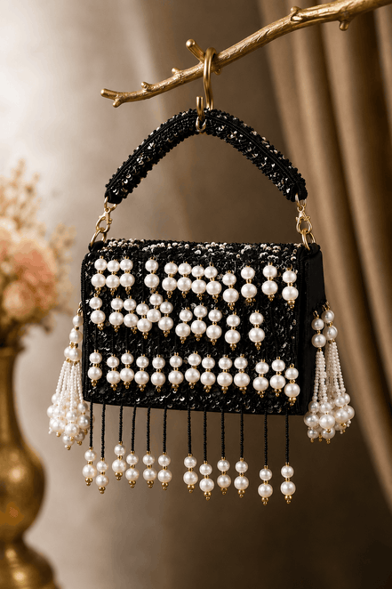 Black pearl shoulder bag with striped bead panels and long dangling pearl tassels