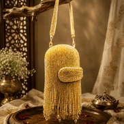 Gold-tone beaded velvet potli clutch with curved clasp flap and long tassel fringe