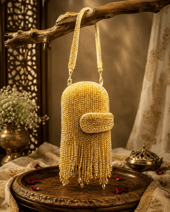 Gold-tone beaded velvet potli clutch with curved clasp flap and long tassel fringe