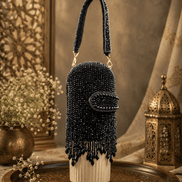 Black beaded velvet potli clutch with rounded flap and dangling tassel fringe