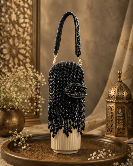 Black beaded velvet potli clutch with rounded flap and dangling tassel fringe