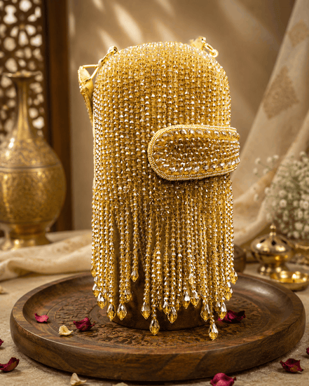 Gold-tone beaded velvet potli clutch with flap and chain fringe handle