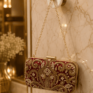 Wine red beaded clutch with gold chain strap and rectangular frame clasp