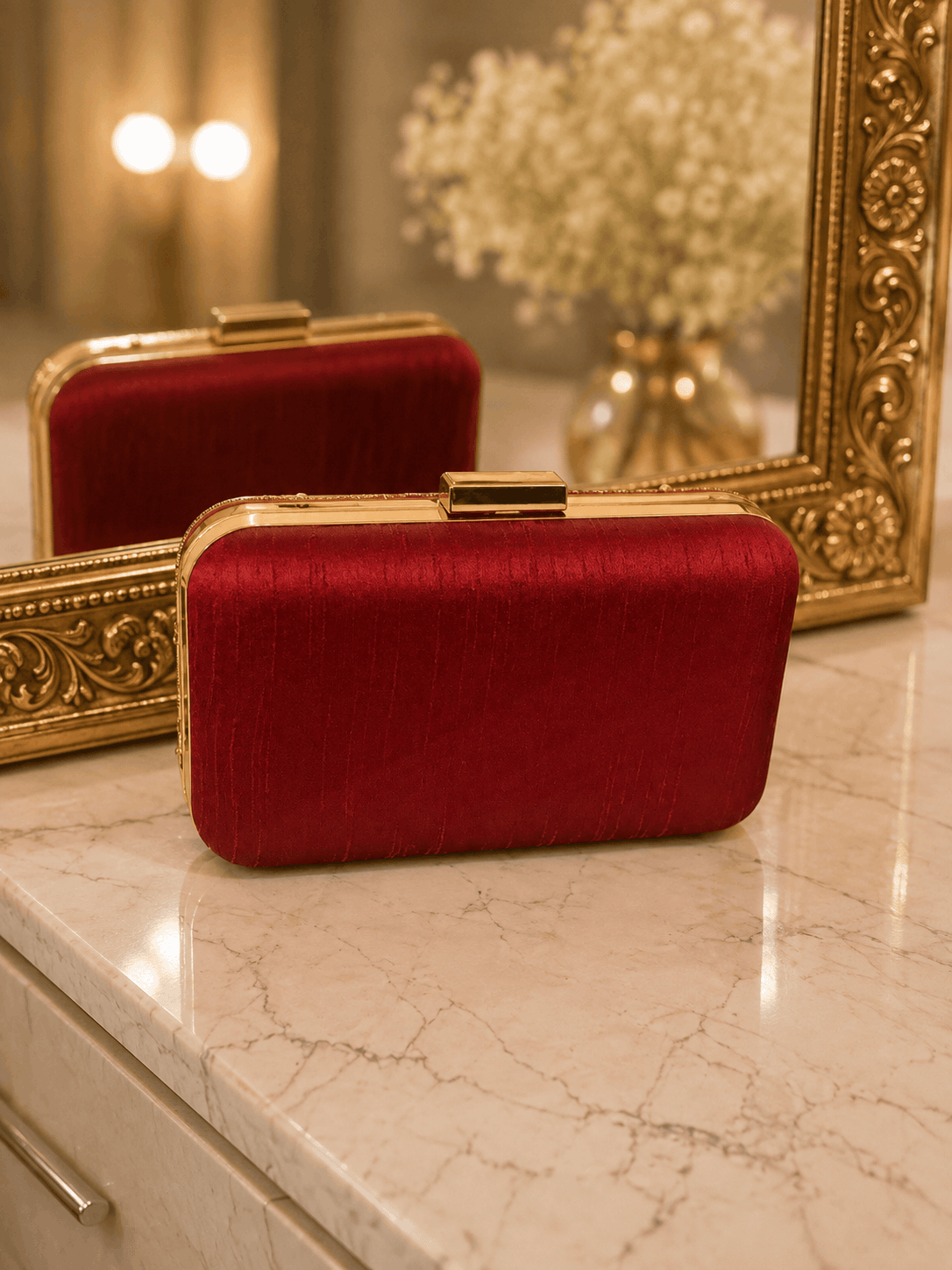 Wine red textured clutch with gold top clasp, side view