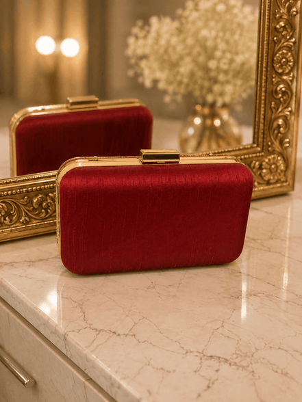 Wine red textured clutch with gold top clasp, side view
