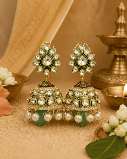 Gold-tone kundan jhumka earrings with green centers and pearl fringe, teal drops