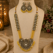 Gold-tone beaded long necklace set with ornate yellow pendant and matching earrings