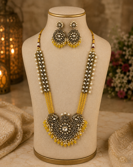 Gold-tone beaded long necklace set with ornate yellow pendant and matching earrings