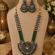 Gold-tone beaded long necklace set with green pendant center and matching earrings