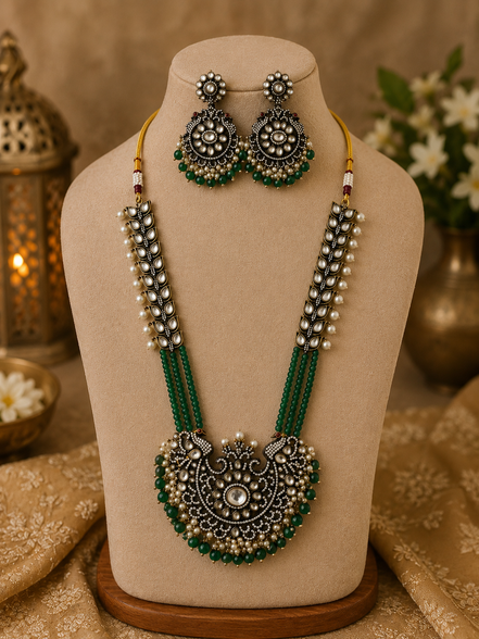 Gold-tone beaded long necklace set with green pendant center and matching earrings