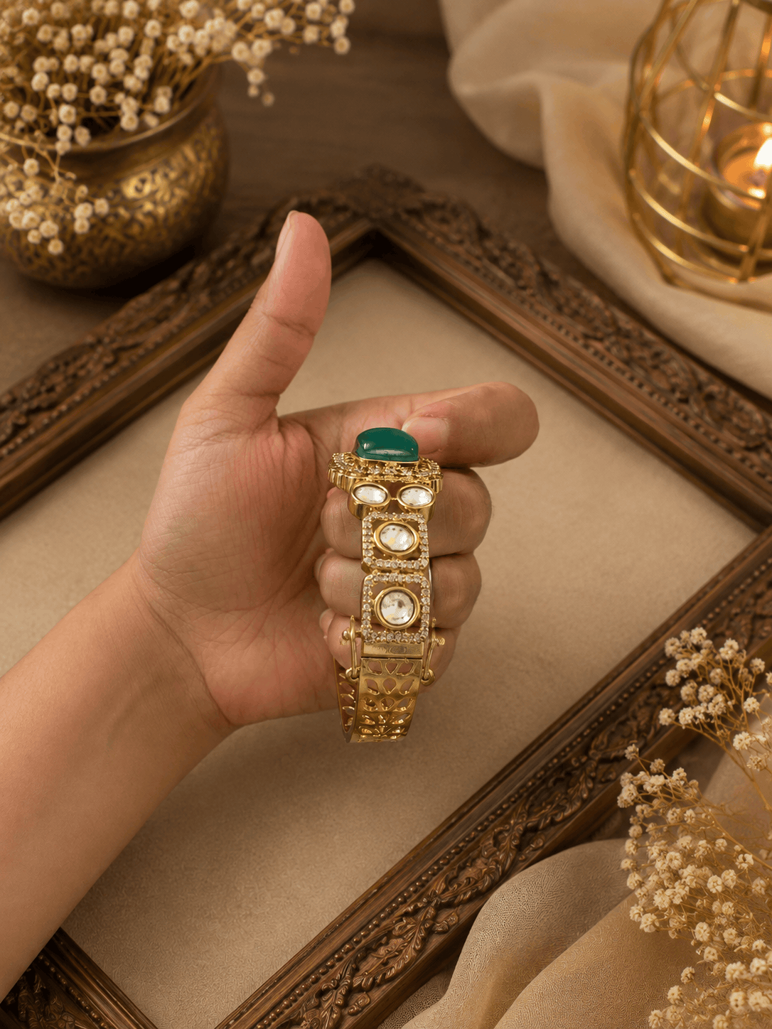 Gold Kada bracelet with green oval stones and three round pearl settings