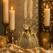 Gold beaded potli bag with drawstring top and dangling pearl tassel handles