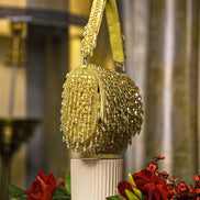 Gold crystal shoulder bag with tassel-like beaded fringe and chain strap