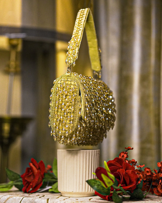 Gold crystal shoulder bag with tassel-like beaded fringe and chain strap