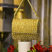 Gold crystal shoulder bag with beaded mesh body and fringed top
