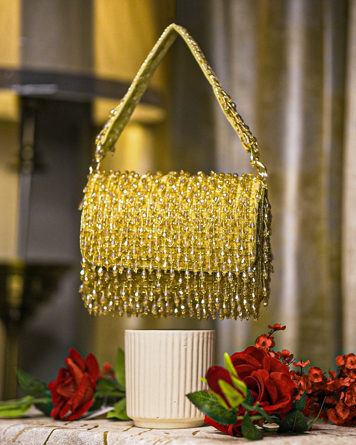 Gold crystal shoulder bag with beaded mesh body and fringed top