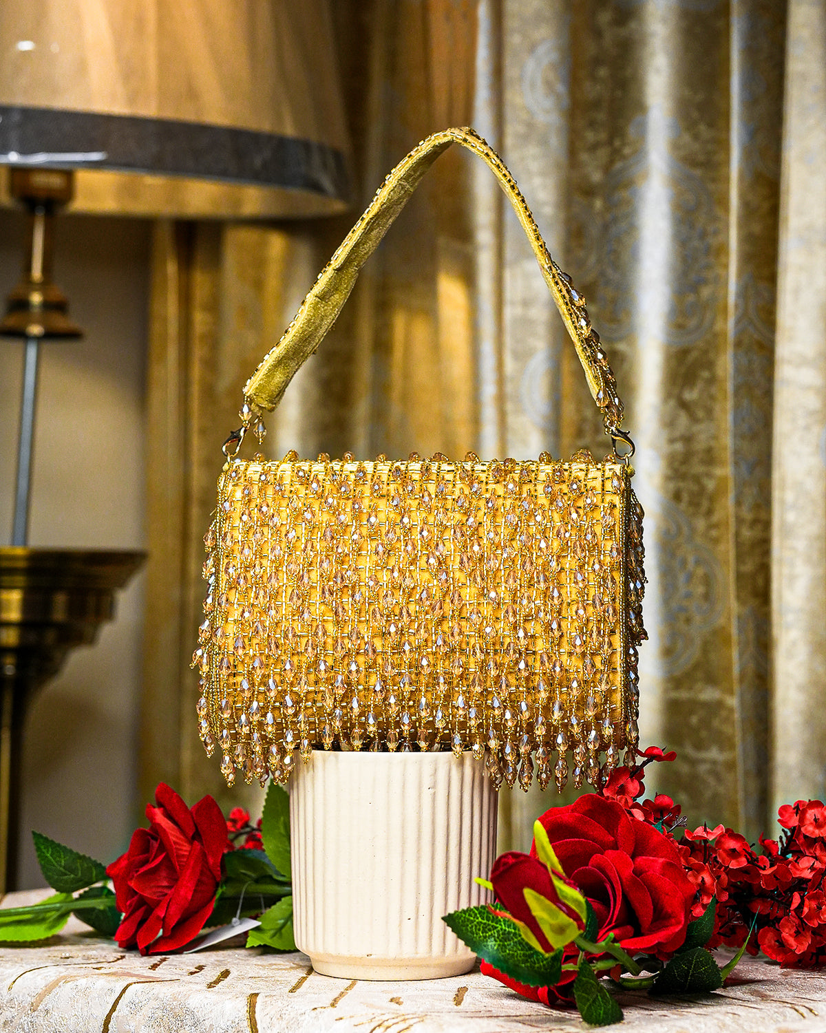 Gold crystal shoulder bag with top handle and dense beaded fringe