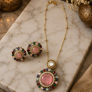Gold-tone necklace set with pink center circular pendant and round stud earrings, multicolor halos