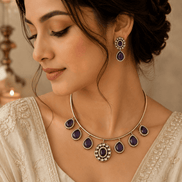 Gold-tone necklace with purple teardrop drops and matching earrings