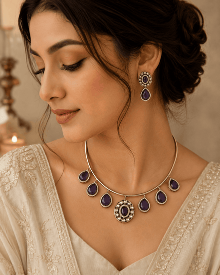 Gold-tone necklace with purple teardrop drops and matching earrings