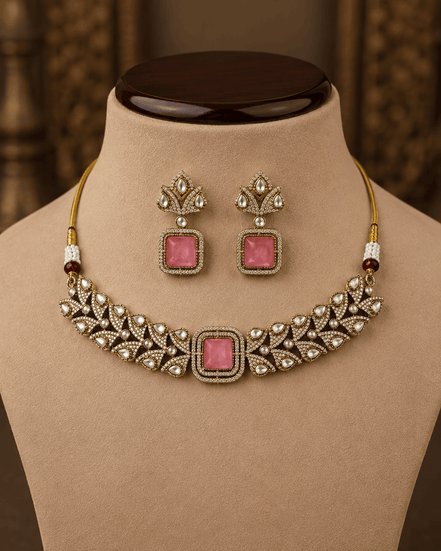 Gold-tone choker with ruby-pink square center stone and matching stud drop earrings display.