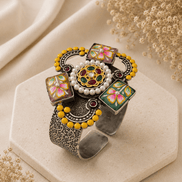 Decorative silver cuff with yellow bead edge, multicolor floral enamel blocks, round center gem