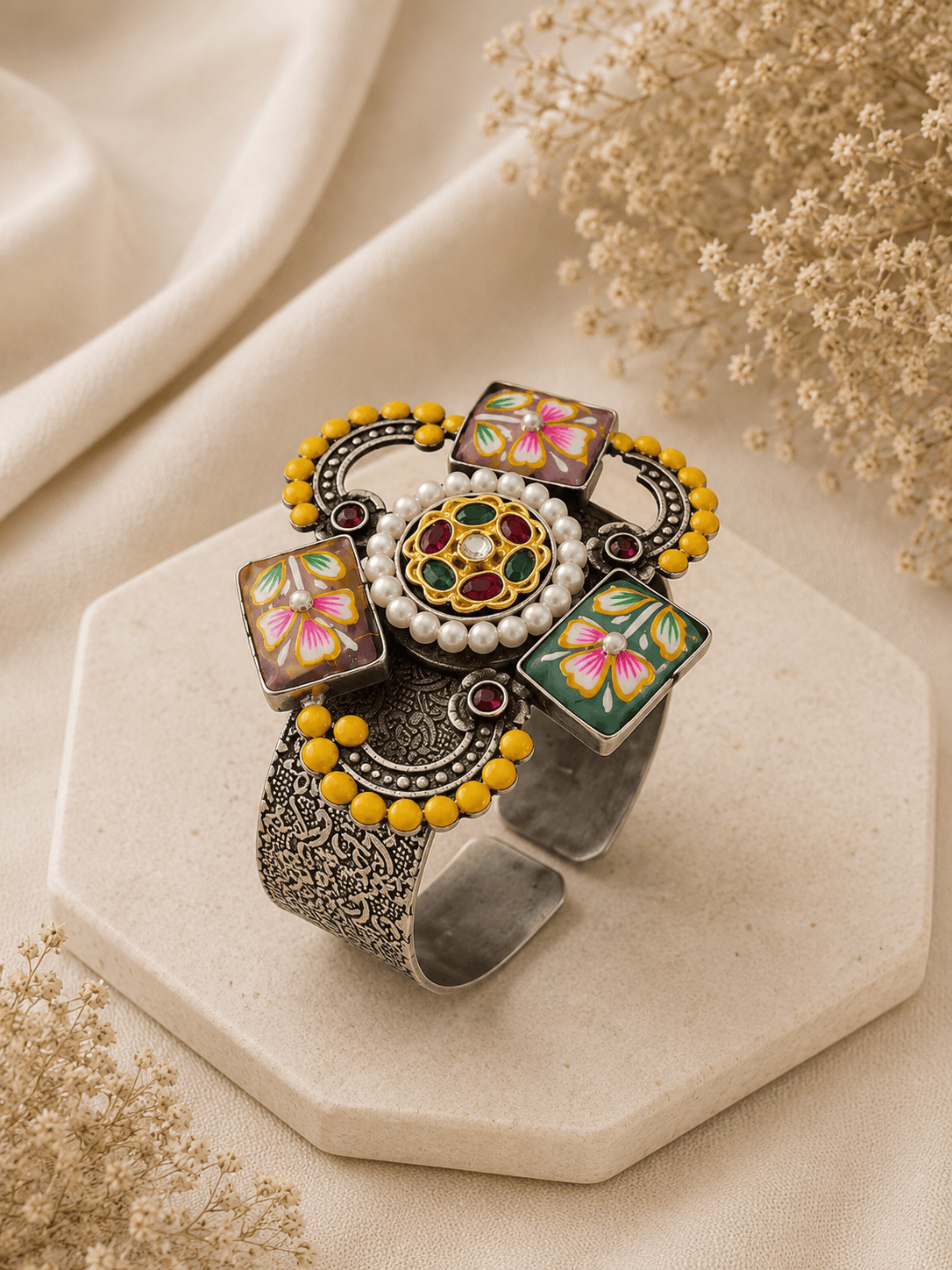 Decorative silver cuff with yellow bead edge, multicolor floral enamel blocks, round center gem