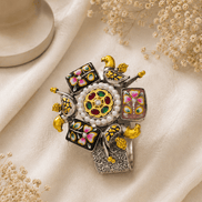Ornate floral cuff bracelet with gold beads, colorful enamel squares, and jeweled center
