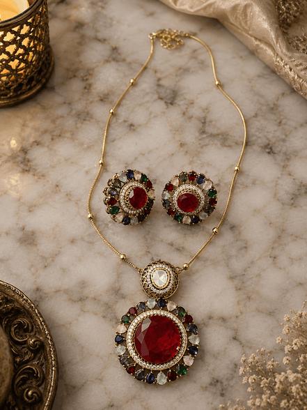 Gold-tone necklace and round stud earrings with red and green center stones, blue accents
