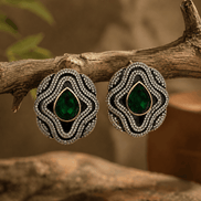 Brass-tone statement stud earrings with dark green teardrop center and crystal frame