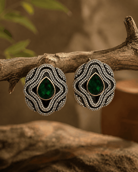 Brass-tone statement stud earrings with dark green teardrop center and crystal frame