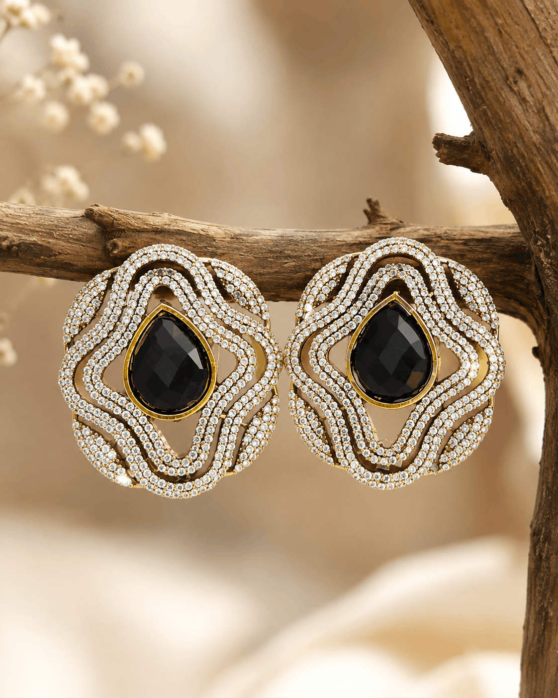 Brass-tone statement stud earrings with black teardrop center in double crystal rows
