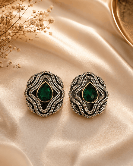 Brass-tone statement stud earrings with green teardrop center and crystal surround
