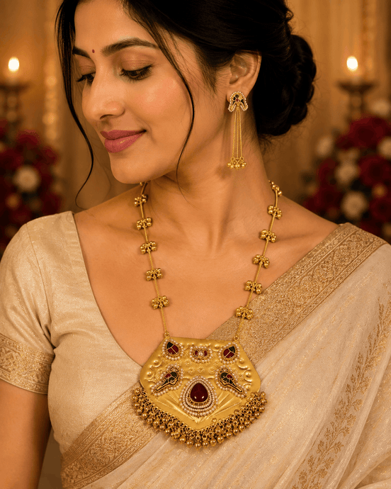 Gold-tone jewelry set: necklace with kundan pendant and dangling earrings on model