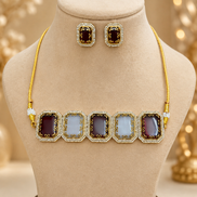Gold-tone beaded choker with alternating dark and light square enamel links on bust