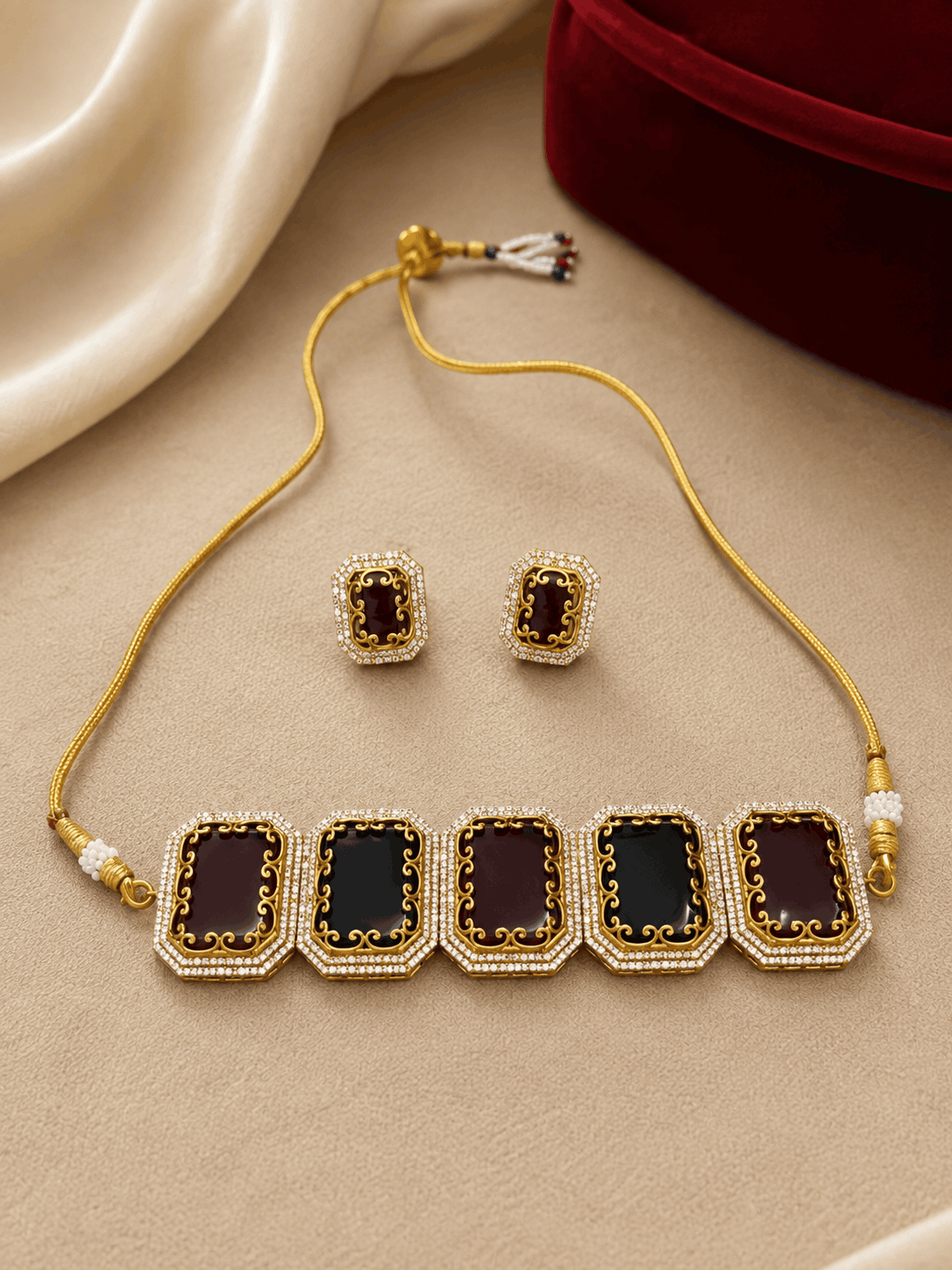 Statement choker set with gold cord and square enamel links, paired with stud earrings