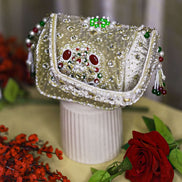 Beige jeweled box clutch with ornate front frame, pearl-like bead fringe, short handle