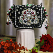 Black embellished box clutch with sparkling gem front and dangling red-green bead tassels