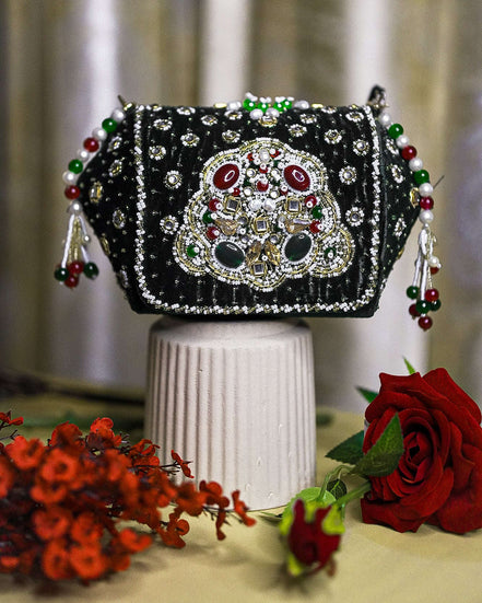 Black embellished box clutch with sparkling gem front and dangling red-green bead tassels