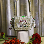 Beige-gold embellished box clutch with jeweled front and small dangling bead tassels