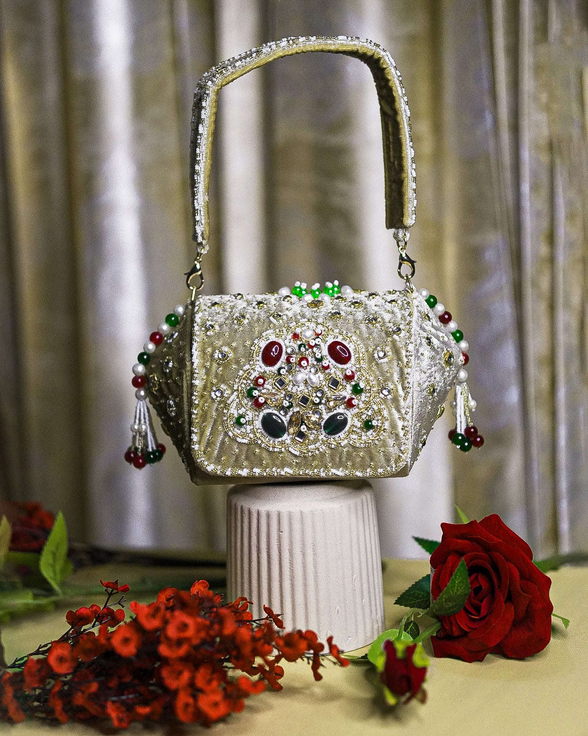 Beige-gold embellished box clutch with jeweled front and small dangling bead tassels