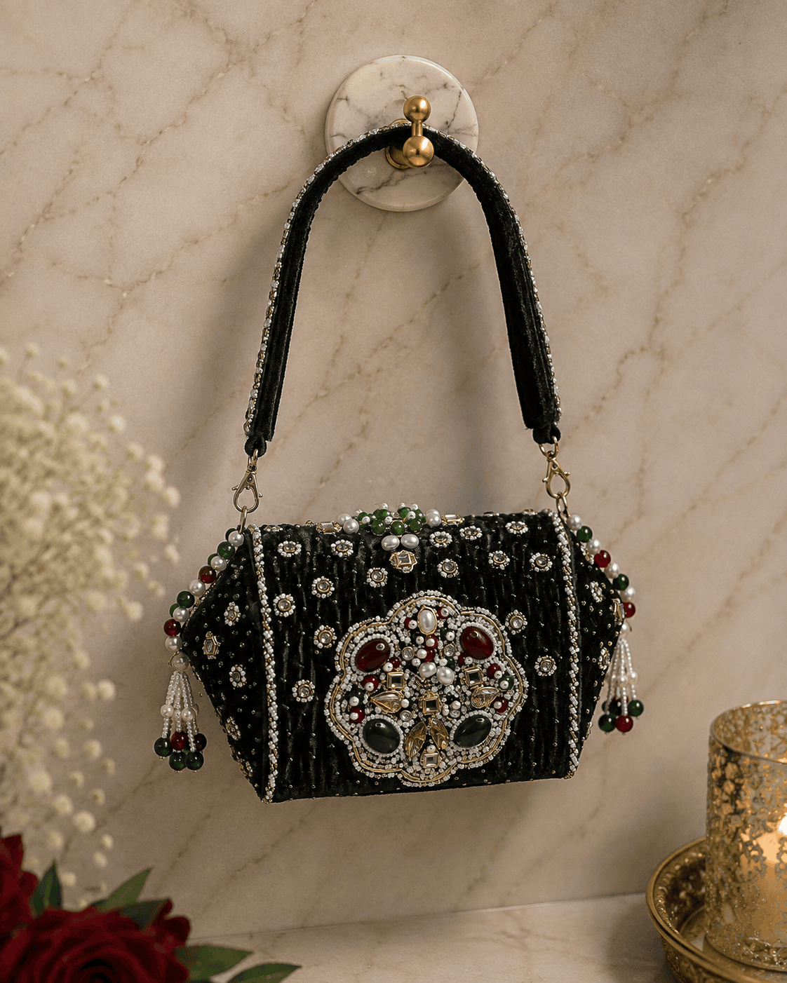 Black beaded box clutch with ornate centerpiece and dangling tassel details