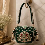 Emerald green embellished box clutch with ornate central motif and beaded fringe tassels