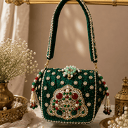 Emerald green jeweled box clutch with rounded beaded top handle and decorative front