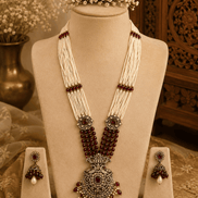 Maroon beaded pearl necklace set with gold-tone pendant and matching stud earrings