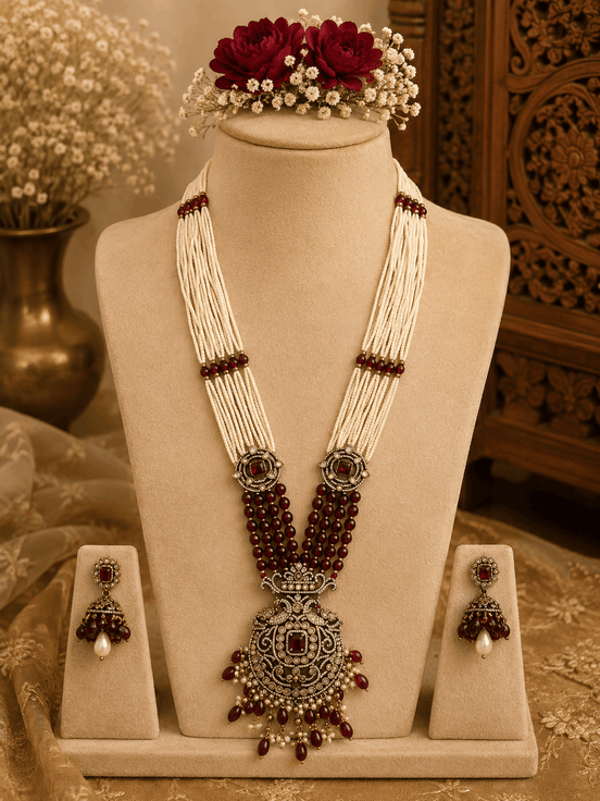 Maroon beaded pearl necklace set with gold-tone pendant and matching stud earrings